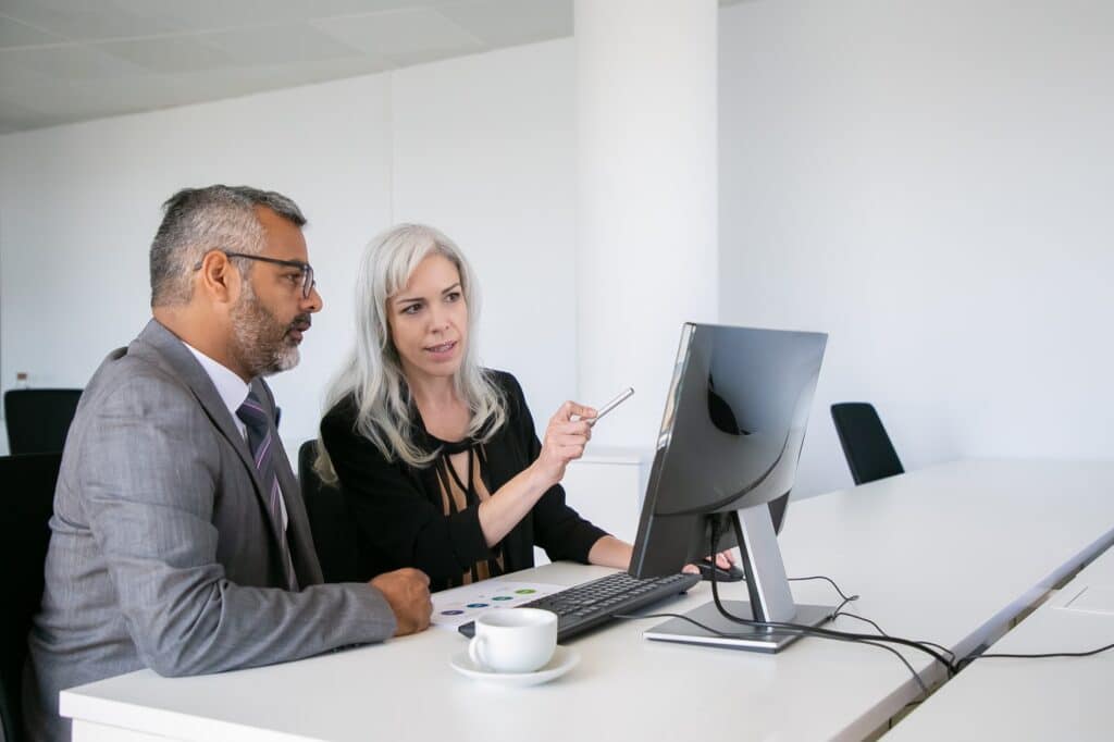 Immigration lawyer and client reviewing information together during a professional office consultation