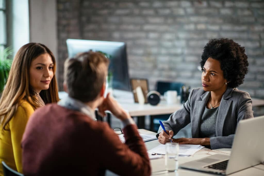 Lawyer advising a couple on a spousal sponsorship application