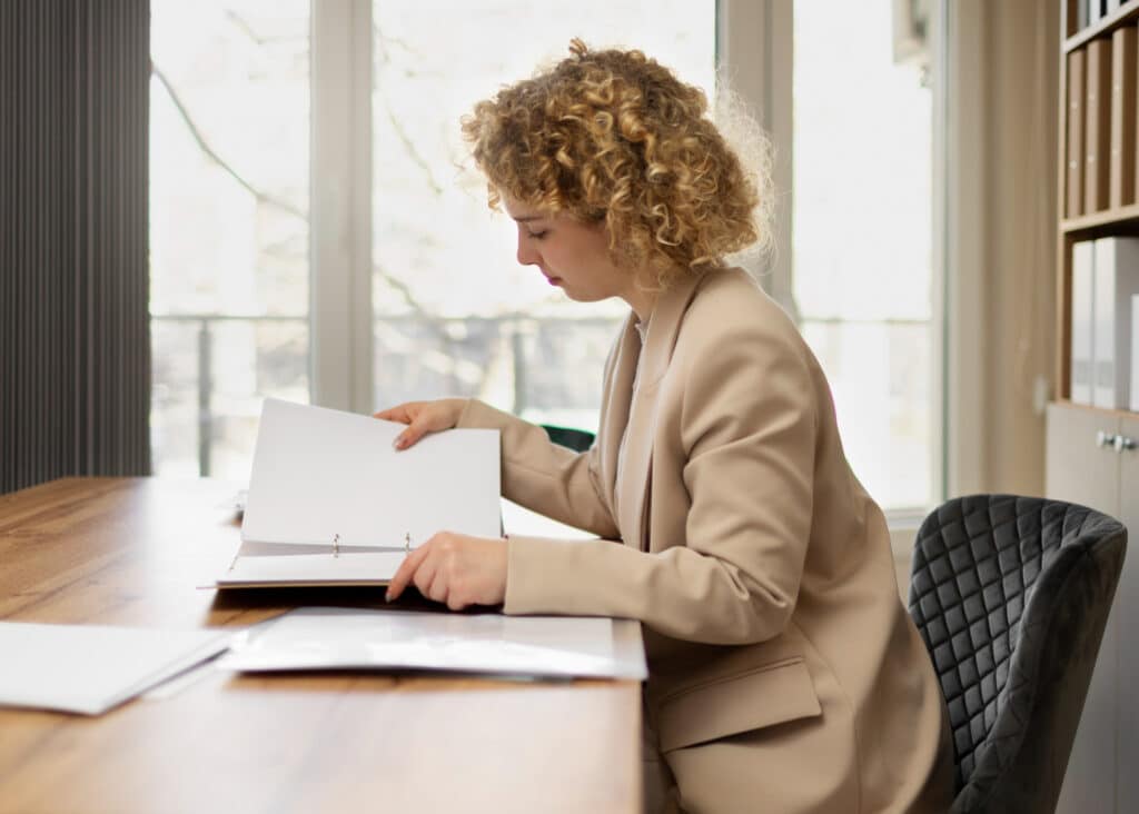 Lawyer organizing case documents at a conference table